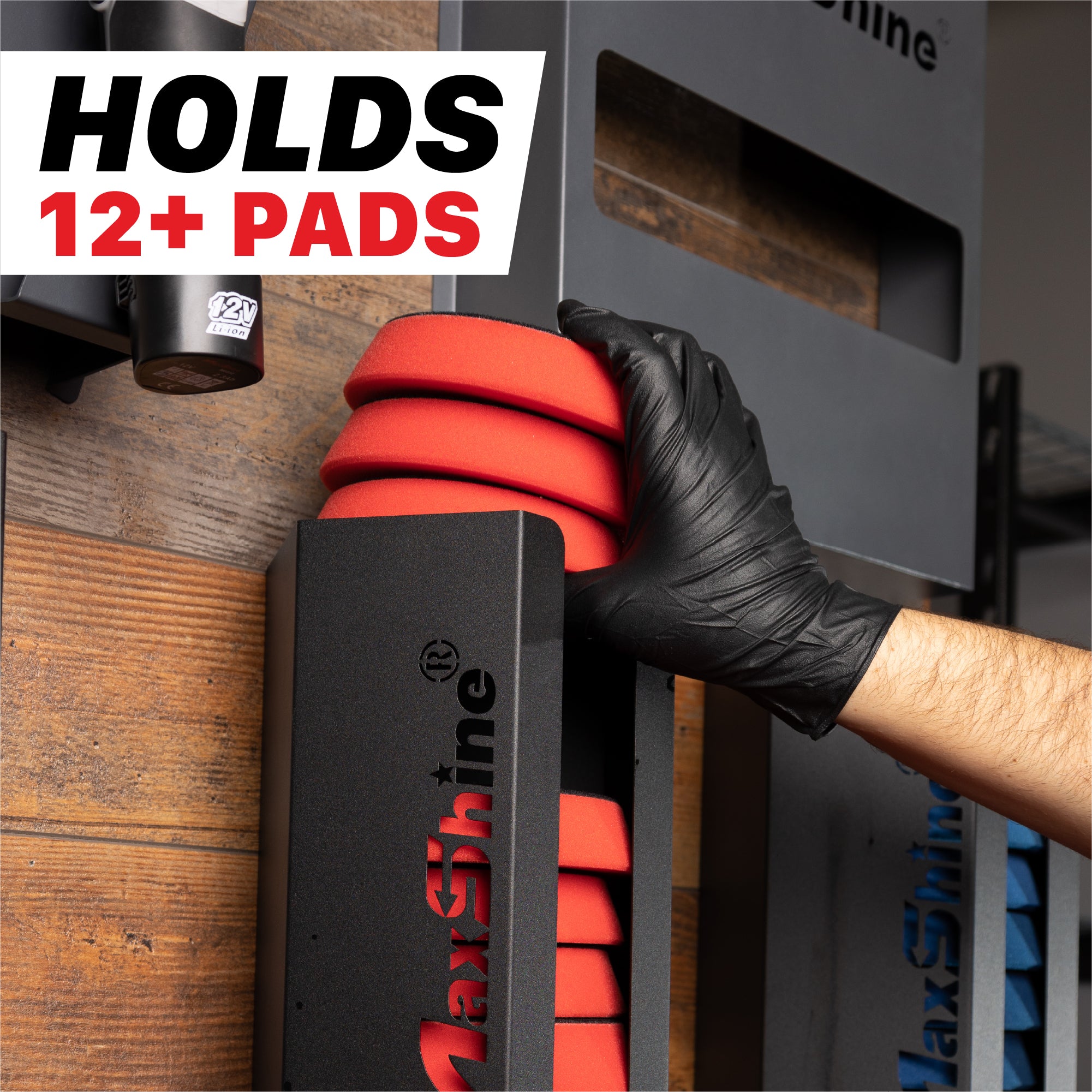 A black MaxShine branded wall-mounted rack holding red polishing pads, with a gloved hand adjusting one pad. Large text in the top left reads 'HOLDS 12+ PADS'. Polisher Pads Holders