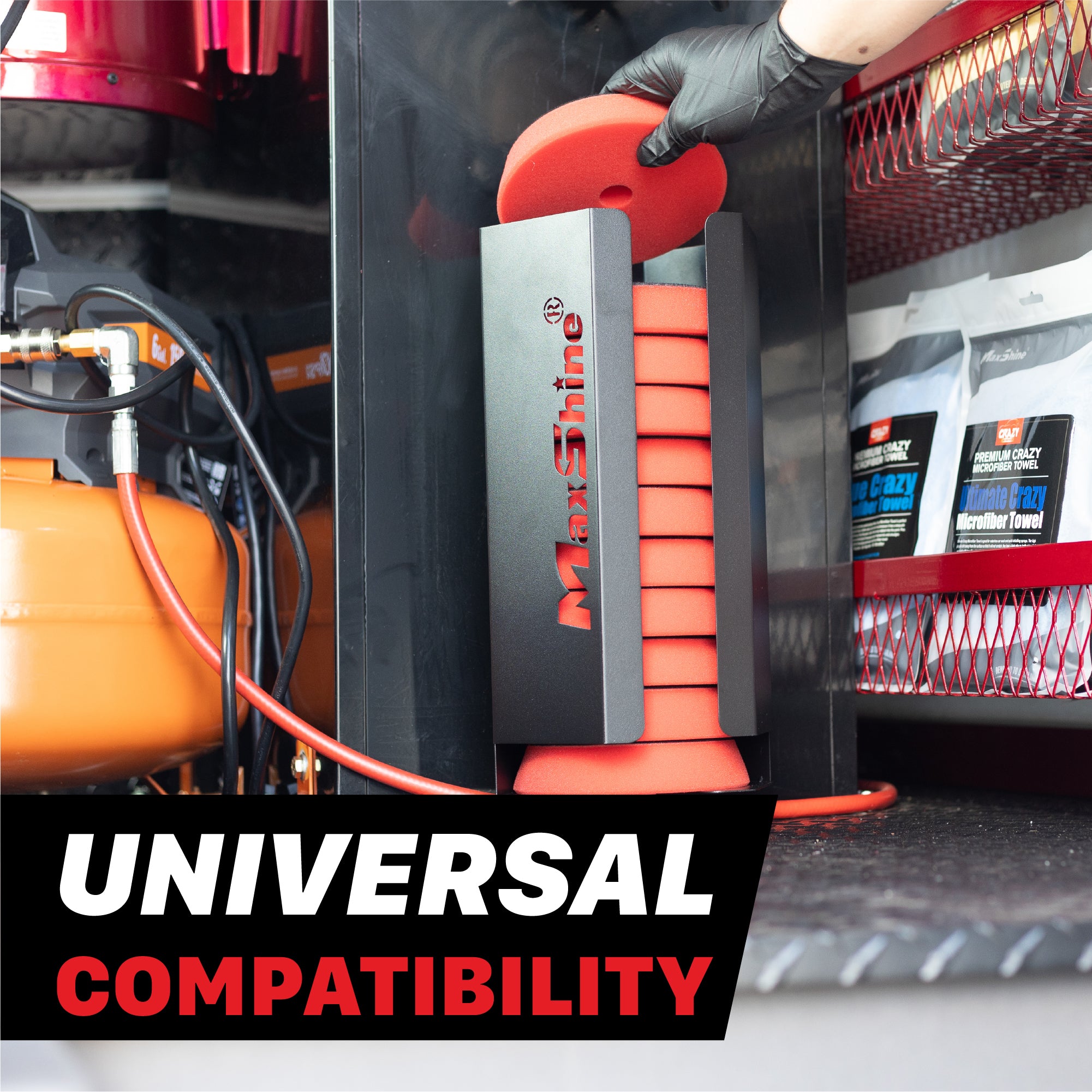 A black MaxShine polishing pads wall mount filled with red polishing pads, one being held by a gloved hand inside a mobile detailing van, with an orange air compressor on the left and product packaging on a red shelf in the background. A text overlay at the bottom reads 'UNIVERSAL COMPATIBILITY'. Polisher Pads Holders
