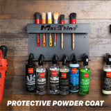 MaxShine brush holder mounted on a rustic wood wall, holding several cleaning brushes above and below a row of MaxShine spray bottles. Large text at the bottom reads PROTECTIVE POWDER COAT. H06 Wall Mount Tool Holder