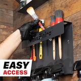 A black MaxShine wall-mounted brush holder with several detailing brushes and spray bottles hanging on it, shown in a real environment against a wood-paneled wall. A gloved hand is reaching for one of the brushes, and a white badge reading 'EASY ACCESS' appears in the lower left corner. H06 Wall Mount Tool Holder