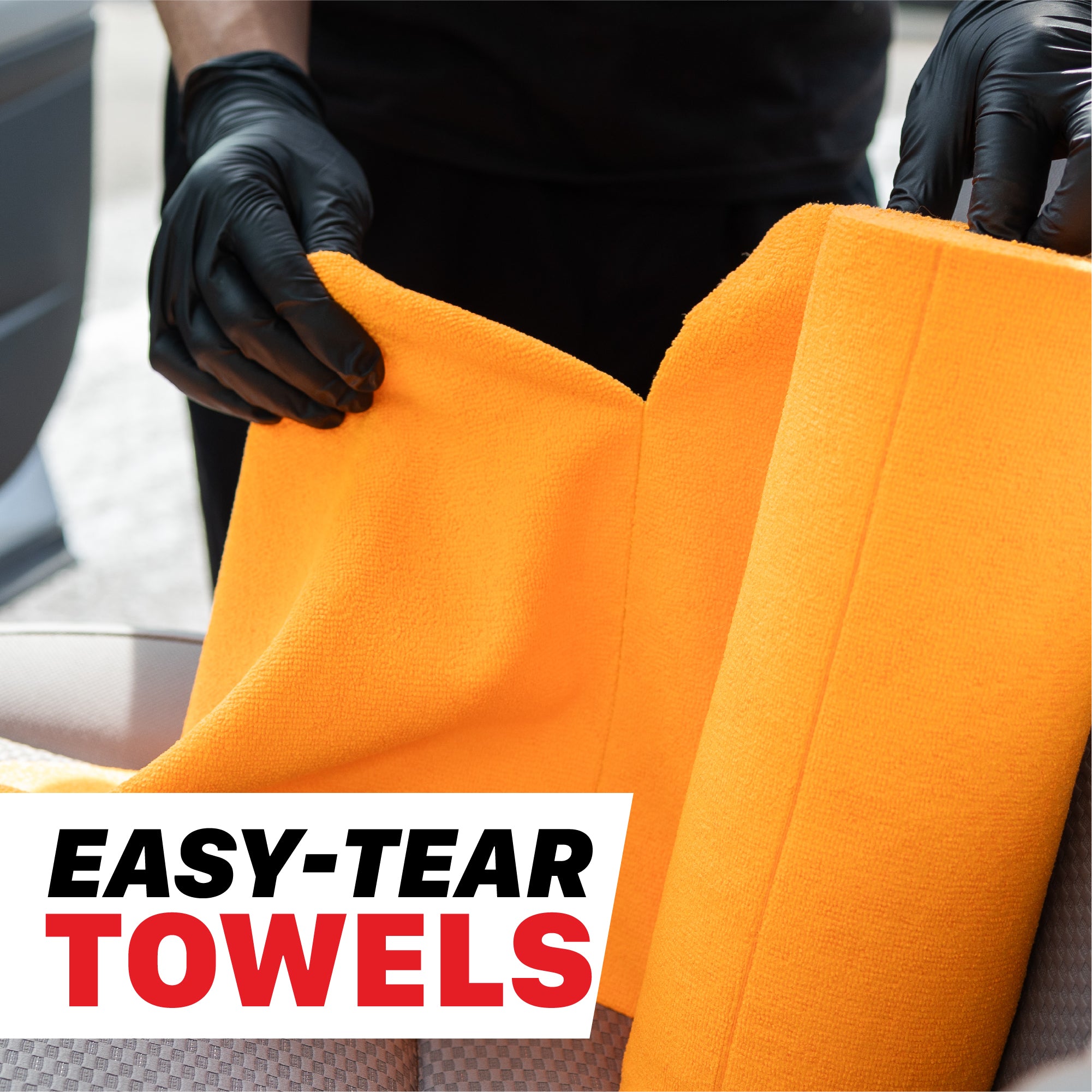 A person wearing black gloves holds open a bright orange towel, with a white text box at the bottom reading 'EASY-TEAR TOWELS'. 1103030 260GSM Microfiber Tear-Away Towel Roll