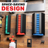 Three wall-mounted polishing pad storage organizers in black, holding green, red, and blue pads, mounted on a wood plank wall. A MaxShine foam cannon and other garage storage items are visible, with a bold text overlay reading 'SPACE-SAVING DESIGN'. Polisher Pads Holders