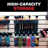Wall-mounted MaxShine brush and tool storage rack with multiple black hanging holders, shown with various cleaning brushes and bottles below on a slatwall. Large text at the top reads 'HIGH-CAPACITY STORAGE'. H06 Wall Mount Tool Holder