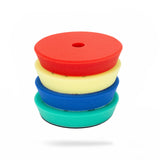 A stack of four foam polishing pads in red, pale yellow, blue, and green, centered on a plain white background. 5HPP Polisher Foam Pads | High Pro Polishing Pads Pack - 5in