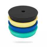 A stack of four foam polishing pads in black, yellow, blue, and green, shown on a clean white background. 202175-KIT Polisher Foam Pads | High Pro Polishing Pads Pack - 5in