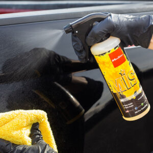 Mist Enhance and Protect Car Coating Spray Sealant on Black Car with Yellow Microfiber Towel